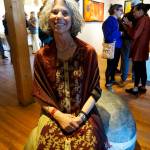 Photo by Michael Armstrong/Homer News Melisse Reichman sits on her sculpture, &ldquo;Pocket Pebble,&rdquo; at the Friday, June 1 opening of her show at Bunnell Street Arts Center. Anchorage artist Graham Dane also shows his works.