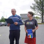Homer Mayor Bryan Zak reads a Mayoral Recognition recognizing June as Homer Pride Month at about 6 p.m. Monday, June 11, 2018 outside Homer City Hall in Homer, Alaska. A crowd of about 75 people attended in support of Pride Month. Council members Shelly Erickson, Heath Smith and Thomas Stroozas notified the city clerk that they would not attend the June 11 meeting, forcing its cancellation because of lack of a quorum. Catriona Reynolds, right, listens to Zak. She asked the mayor for the recognition. (Photo by Michael Armstrong/Homer News)