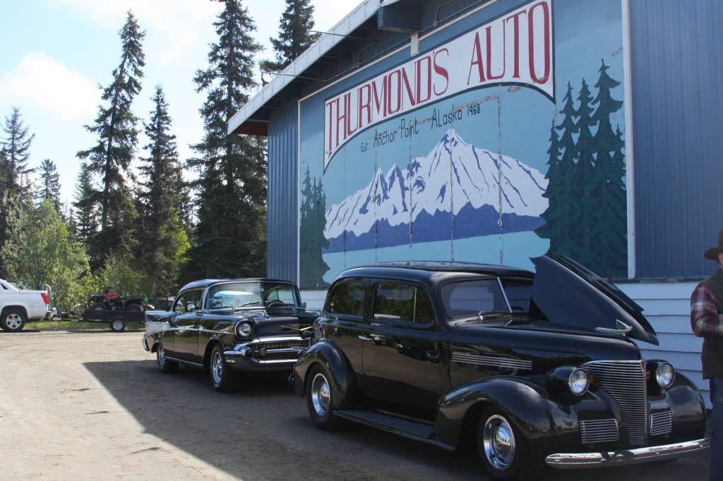 Classic cars owned by members of Kaknu Kruzers are displayed under the mural at Thurmond&rsquo;s Far West Auto during their fourth annual Customer Appreciation Day on Saturday, June 9 in Anchor Point, Alaska. (Photo by Delcenia Cosman)