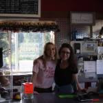 (From left to right) Thurmond&rsquo;s employees Stacey Cole and Mikylla Blauvelt pose behind the front counter of Thurmond&rsquo;s Far West Auto during the fourth annual Customer Appreciation Day on Saturday, June 9 in Anchor Point, Alaska. (Photo by Delcenia Cosman)