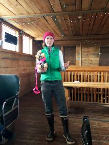 Bailey Lowney shows a group of women an example of the kind of skates needed for roller derby during an informational meeting Friday, June 29, 2018 at Alices Champagne Palace in Homer, Alaska. Lowney, a former derby player, and several other local women are working to form Homers first roller derby team. (Photo by Megan Pacer/Homer News)
