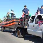 Members of the U.S. Coast Guard stationed in Homer proceed down Pioneer Avenue in their float during this years Independence Day parade Wednesday, July 4, 2018 in Homer, Alaska. The represented the U.S. Coast Guard Cutter Hickory, also known as Bull of the North. (Photo by Megan Pacer/Homer News)