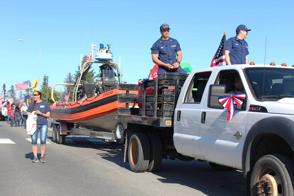 Members of the U.S. Coast Guard stationed in Homer proceed down Pioneer Avenue in their float during this years Independence Day parade Wednesday, July 4, 2018 in Homer, Alaska. The represented the U.S. Coast Guard Cutter Hickory, also known as Bull of the North. (Photo by Megan Pacer/Homer News)