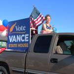 Sarah Vance, who is running for a seat in the Alaska House of Representatives, rides in the back of a truck during this years Independence Day parade Wednesday, July 4, 2018 in Homer, Alaska. Several political figures and candidates had floats in this years parade. (Photo by Megan Pacer/Homer News)