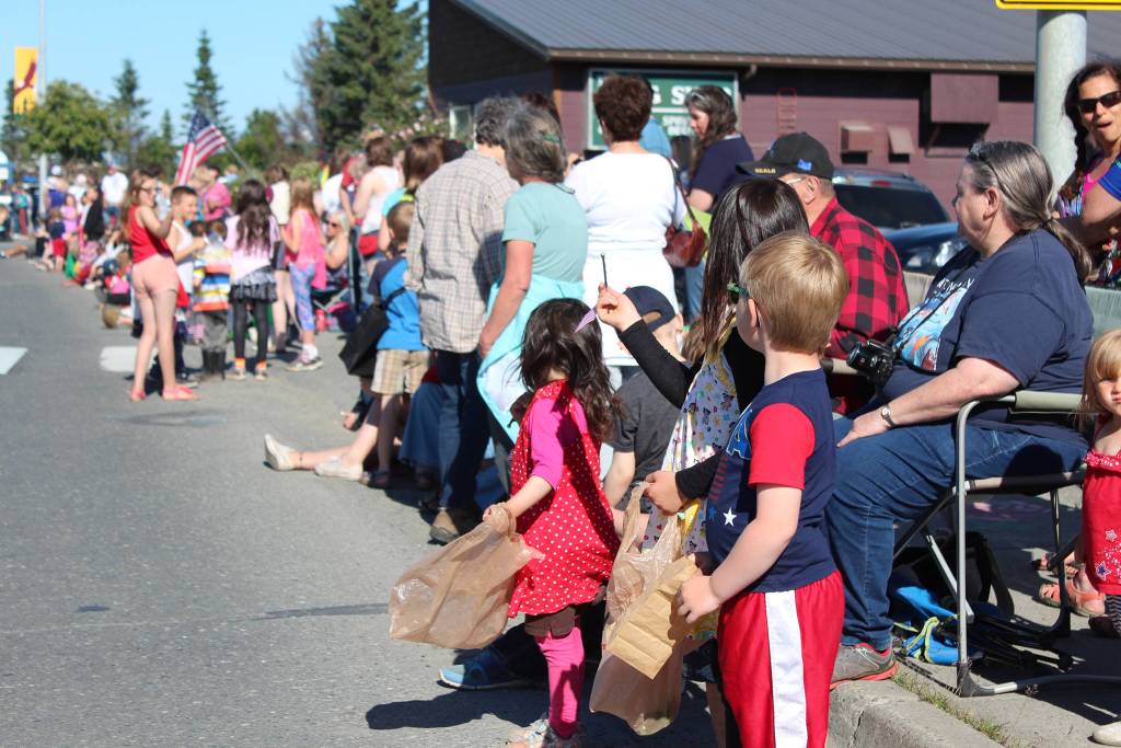 Homer area families line Pioneer Avenue in anticipation of this years Independence Day parade Wednesday, July 4, 2018 in Homer, Alaska. (Photo by Megan Pacer/Homer News).