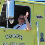 Homer Volunteer Fire Department Chief Terry Kadel waves to the crowd gathered on Pioneer Avenue during this years Independence Day parade Wednesday, July 4, 2018 in Homer, Alaska. (Photo by Megan Pacer/Homer News)