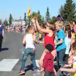 Children scramble for candy tossed from passing floats and parade walkers during this years Independence Day parade Wednesday, July 4, 2018 on Pioneer Avenue in Homer, Alaska. (Photo by Megan Pacer/Homer News)