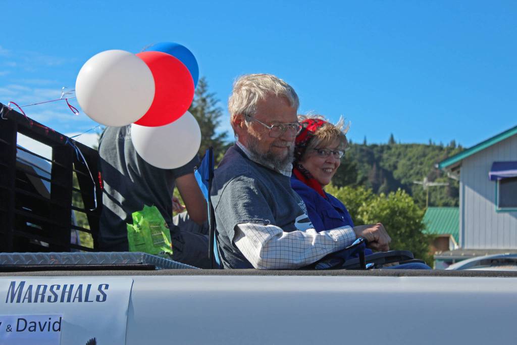 Ruby and David Nofziger ride through this years Independence Day parade, serving as the grand marshals, Wednesday, July 4, 2018 in Homer, Alaska. This years theme was volunteerism. (Photo by Megan Pacer/Homer News)