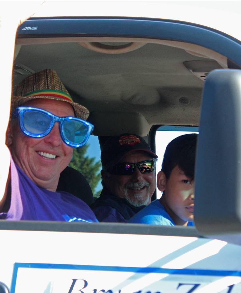 Homer Mayor Bryan Zak waves to families gathered along Pioneer Avenue for the annual Independence Day parade Wednesday, July 4, 2018 in Homer, Alaska. (Photo by Megan Pacer/Homer News)