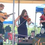 Members of the Scottish band The Fire perform on a small stage at the Kachemak Bay Scottish Highland Games on Saturday, July 7, 2018 at Karen Hornaday Park in Homer, Alaska. The trio also performed at an after party at the Kannery Grill later that evening. (Photo by Megan Pacer/Homer News)