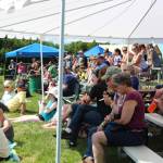 Locals and visitors watch several highland games unfold from a shaded spot on a hill during the Kachemak Bay Scottish Highland Games on Saturday, July 7, 2018 at Karen Hornaday Park in Homer, Alaska. (Photo by Megan Pacer/Homer News)