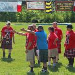 A coach gives novice competitors advice on how to throw a caber on Saturday, July 7, 2018 during the Kachemak Bay Scottish Highland Games at Karen Hornaday Park in Homer, Alaska. Novices must practice before actually participating in the caber throw. (Photo by Megan Pacer/Homer News)