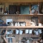 Tools and pieces of art in various stages of completion line the shelves of Jeff and Ranja Deans art studio, shown here during a tour Friday, July 6, 2018 at their home off East End Road near Homer, Alaska. (Photo by Megan Pacer/Homer News)