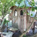 A hand-built chicken coop rests in the shade at the Jeff and Ranja Deans farm on Friday, July 6, 2018 off East End Road near Homer, Alaska. Ranja built the coop specifically to accommodate weather in Alaska, including raising it off the ground to prevent snow build up. (Photo by Megan Pacer/Homer News)
