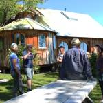 From left to right: Leah Evans Cloud, Jonah Cloud, Jeff Dean, Brad Thornburgh and Ranja Dean chat outside the Deans home down East End Road before a tour on Friday, July 6, 2018 near Homer, Alaska. The Deans open their farm and art studios to interested visitors. (Photo by Megan Pacer/Homer News)