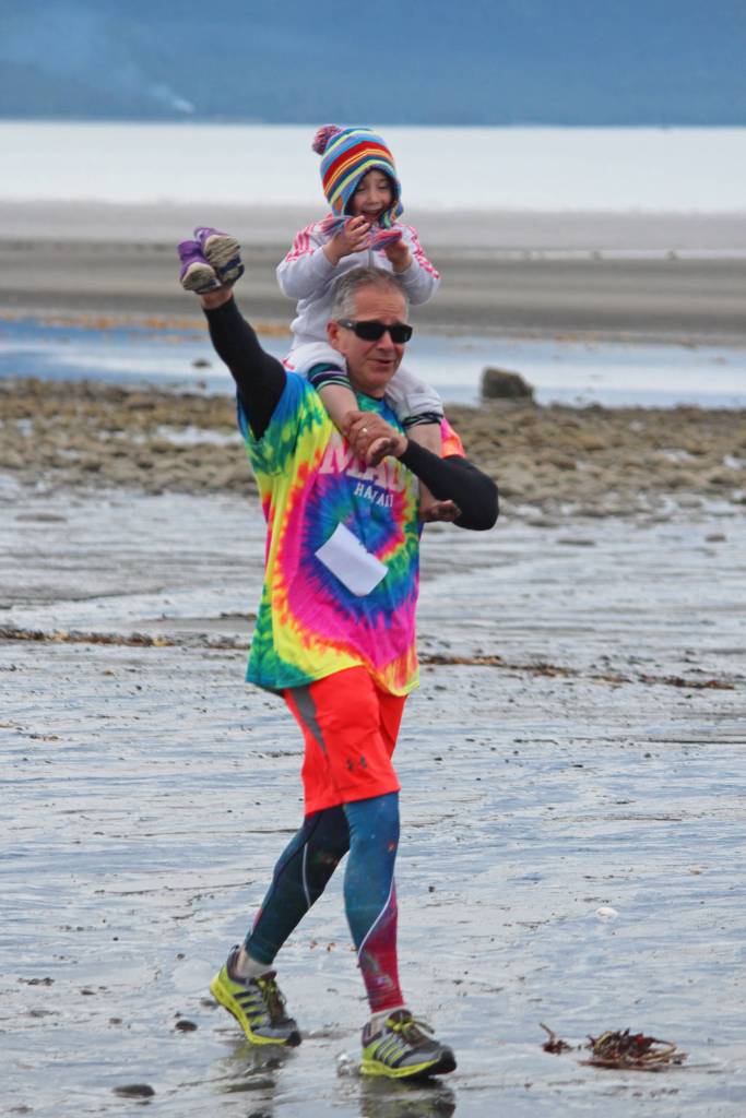 Dennis Mackulin approaches the finish line of the Chariots of Fur 5K race with Isabel Piek on Saturday, July 14, 2018 near Mariner Park in Homer, Alaska. Now in its third year, the race benefits Homer Animal Friends. (Photo by Megan Pacer/Homer News)