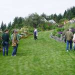 Visitors check out Joan Splinters garden on Reber Road off West Hill Road on July 30, 2017 in Homer, Alaska. Her garden was featured in the Homer Garden Clubs 2017 Summer Garden Tours. (Photo by Michael Armstrong/Homer News)