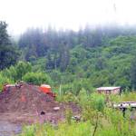 A bulldozer and a pile of gravel block the entrance to a bridge leading to the Glanville homestead on July 23, 2018, near Mile 164 Sterling Highway. Dwight and Diana Glanville filed eviction proceedings against Keith Evans, and in a hearing on July 23, Evans agreed to pack up his possessions no later than Aug. 6, at which time the Glanvilles will open the road so he can leave. (Photo by Michael Armstrong/Homer News)