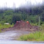 A bulldozer and a pile of gravel block the entrance to a bridge leading to the Glanville homestead on July 23, 2018, near Mile 164 Sterling Highway. Dwight and Diana Glanville filed eviction proceedings against Keith Evans, and in a hearing on July 23, Evans agreed to pack up his possessions no later than Aug. 6, at which time the Glanvilles will open the road so he can leave. (Photo by Michael Armstrong/Homer News)