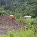 A bulldozer and a pile of gravel block the entrance to a bridge leading to the Glanville homestead on July 23, 2018, near Mile 164 Sterling Highway. Dwight and Diana Glanville filed eviction proceedings against Keith Evans, and in a hearing on July 23, Evans agreed to pack up his possessions no later than Aug. 6, at which time the Glanvilles will open the road so he can leave. (Photo by Michael Armstrong/Homer News)