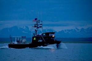 A drift gillnet fishing vessel makes its way out of the mouth of the Kenai River in this July 2016 file photo near Kenai, Alaska. (Elizabeth Earl/Peninsula Clarion0