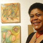 Sadie Mae Millard stands by her three paintings at the opening of the Bunnell Street Arts Center 10x10 show last Friday. Millard painted the works before and after major surgery. -Photo by Michael Armstrong, Homer News