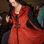 Models try on some of the pieces that will be featured in Saturday’s Wearable Arts show. Decker models a masquerade jacket created by Risa Jackinsky.-Photo by McKibben Jackinsky, Homer News