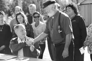 Gov. Sean Parnell shakes hands with Rep. Paul Seaton, R-Homer, after signing House Bill 75 on Tuesday at the Snowshoe Gun Club in Kenai. The bill amends the Pick. Click. Give program to no longer require organizations with a budget of more than $250,000 to be audited. It also allows Alaskans to donate a portion of their permanent fund dividend to sustain the program. -Photo by Kaylee Osowski/Morris News Service - Alaska