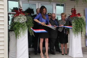 Taya Kyle, the widow of U.S. Navy SEAL and “American Sniper” author Chris Kyle, cuts a ribbon to officially dedicate the Chris Kyle Patriots Hospital in Anchorage on July 28. Part of the United Health Services Inc. network, the facility at North Star Behavioral Health is the only one of 14 similar veterans’ treatment facilities to be named after an individual.-Photo by Elwood Brehmer, Morris News Service - Alaska