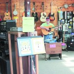Steve Cornish plays music in his new shop, in the same building as the Art Shop Gallery.