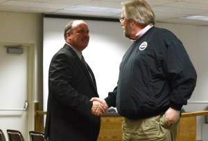 Assistant Superintendent of Instruction Dave Jones congratulates Interim Superintendent Sean Dusek after Dusek is named the new superintendent of schools Tuesday at the Kenai Peninsula Borough Building in Soldotna.-Photo by Kelly Sullivan/ Morris News Service