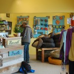 Shoppers browse at Sustainable Wares last Friday. Most of the furnishings are made from repurposed items like thrift store furniture or salvaged wood, such as the counter, which uses cedar from an old sauna.-Photo by Michael Armstrong, Homer News