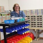 Surrounded by a display of hardware, Chyrell Richardson is enjoying meeting a community need with her new Anchor Point business, “Nutz and Bolts.”-Photo by McKibben Jackinsky, Homer News