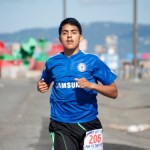 Pedro Ochoa is the first one to cross the finish line of the 2014 10K Run to the Bay Spit Run Saturday, with a time of 36:18.
