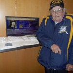 Dottie Holten stands by a plaque honoring her service at the Women in Military Service Memorial for America.-Photo by Darlene Sheldon