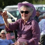 Grand Marshal Daisy Lee Bitter smiles at the crowd lining