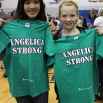 Ruby Holschen, left, and Mya Houglin display T-shirts supporting their friend Angelica Haakenson, 11, of Anchor Point who was injured in a Christmas Day wreck on the Sterling Highway.-Photo by McKibben Jackinsky, Homer News