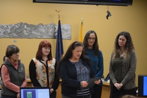 Homer Mayor Beth Wythe, center, reads a proclamation at the Jan. 12 Homer City Council meeting declaring Friday as Big Read Day and encouraging people to take part in the Homer Public Library’s Big Read for Ray Bradbury’s “Fahrenheit 451.”  The Big Read starts with a kick-off bonfire at 7 p.m. Friday at the Homer Public Library. Watching are Marylou Burton, treasurer, Friends of the Homer Public Library; Library Advisory Board student member Sabina Karwowski; Library Director Anne Dixon; and Friends of the Homer Public Library Coordinator Erin Hollowell.-Photo by Michael Armstrong, Homer News