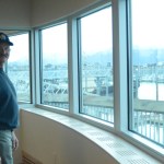 Harbormaster Bryan Hawkins stands by one of the windows overlooking the harbor in the new Harbormaster’s Office building.-Photo by Michael Armstrong, Homer News