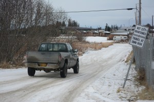 Several people in a truck drive down Waddell Way on Tuesday afternoon. The city received a $1.4 million grant last year to improve and expand the unmaintained road from Lake Street to Heath Street and connect with an existing paved section by the post office, but the Homer City Council is considering using some of that money for the Public Safety Building project.-Photo by Michael Armstrong, Homer News