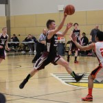 Nikolaevsk Warrior Felemon Molodih, 33, flies high during the team’s game against the Noorvik Bears on Saturday at the State 1A tournament in Anchorage.-Photo by McKibben Jackinsky