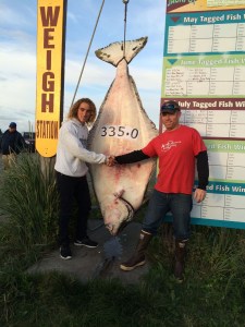 Jackson Hobbs, 16, of Franklin, Idaho, is congratulated by Capt. Travis Larson of Alaska Premier Sportfishing for the 335-pound halibut Hobbs caught while fishing with Larson on Tuesday.-Photo provided