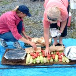 Toni Adams of Sterling and Patti Boiley of Homer prepare food for the fire at Homer Yacht Club’s 2005 clam bake at Tutka Bay.-Photos by McKibben Jackinsky, Homer News