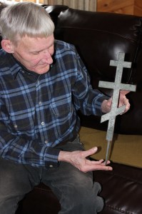 Peter Zollars displays the Russian Orthodox cross found on an island in Kachemak Bay.-Photos by McKIbben Jackinsky, Homer News