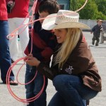 Megan Ridley, Miss Wrangler National Patriot/2009 Miss Rodeo America, helps a youngster learn some roping tricks during a visit by the Wrangler National Patriot Memorial Day Tour on Sunday. -Photo provided