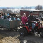 Kids enjoy a tour of the fields in a trailer pulled by a three-wheeler.-Photo by Carmen Field, Nature Rocks