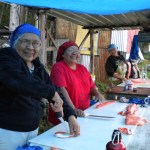 Helen, Faith and Kathleen Peters cut fish at Rampart Rapids on the Yukon River in this undated photo. Subsistence fishing for king salmon has been greatly restricted in the last several years to meet escapement goals and pass enough fish through to Canada.-Photo courtesy of Stan Zuray