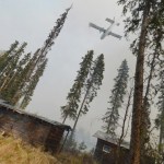 A plane sprays foam over a portion of the 156,041 acre Funny River Horse Trail wildfire Sunday May 25, 2014 in the Funny River community of Soldotna, Alaska. Several hundred homes were evacuated after the fire flared briefly over a fire break set up about one-quarter mile south of the community.-Photo by Rashah McChesney/Morris News Service-Peninsula Clarion