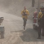 Spectators motored close to shore on the Kenai River as firefighters from Central Emergency Services fought to keep a portion of the 156,000 acre Funny River Horse Trail wildfire from burning into a neighorhood in off of Funny River Road Monday May 26, 2014 in Soldotna, Alaska. The wildfire ignited a trailer across the river in the Kenai Keys neighborhood — but firefighters extinguished the blaze.-Photo by Rashah McChesney/Morris News Service-Peninsula Clarion