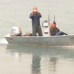 Central Emergency Services firefighters Jayson Cooper, Josh Thompson and Terry Bookey watch as aerial support arrives to dump retardent, foam and water on an extension of the Funny River Horse Trail wildfire Sunday May 25, 2014 in the Funny River community in Soldotna, Alaska. The crew, along with a few firefighters from the Kenai fire department, responded to the advancing fire at 34754 Killey Street along the banks of the Kenai River — the area had been evacuated half an hour before they arrived.-Photo by Rashah McChesney/Morris News Service-Peninsula Clarion